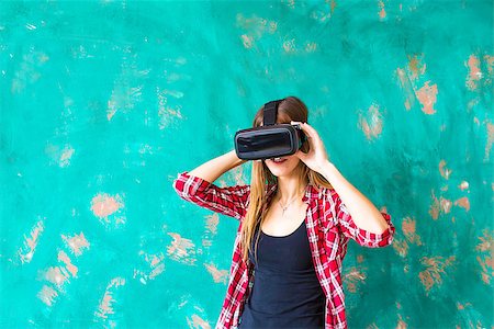 technology, virtual reality, entertainment and people concept - happy young woman with virtual reality headset or 3d glasses and headphones over gray background Photographie de stock - Aubaine LD & Abonnement, Code: 400-08752450