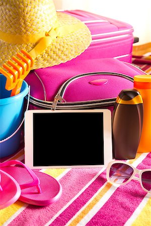 empty suitcase - Empty touch screen tablet with colorful beach towel, sunglasses, sun creams and beach accessories. Photographie de stock - Aubaine LD & Abonnement, Code: 400-08753278