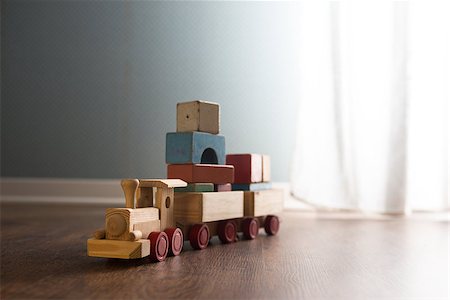 dollhouse room - Vintage wooden toy train next to a window on hardwood floor. Stock Photo - Budget Royalty-Free & Subscription, Code: 400-08753382