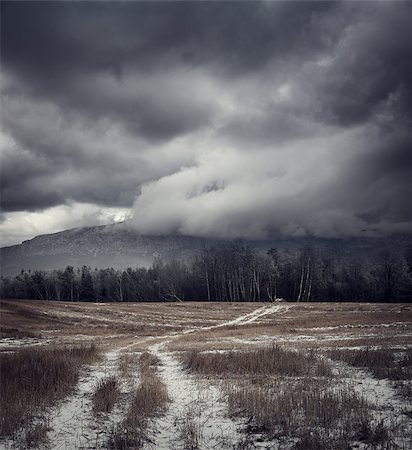 spooky field - Dark Gloomy Landscape with Country Road in Snow. Moody Sky Background with Epic Dramatic Clouds around Mountains. Cold Winter Fantasy Scenery. Toned HDR Styled Photo. Stock Photo - Budget Royalty-Free & Subscription, Code: 400-08776077