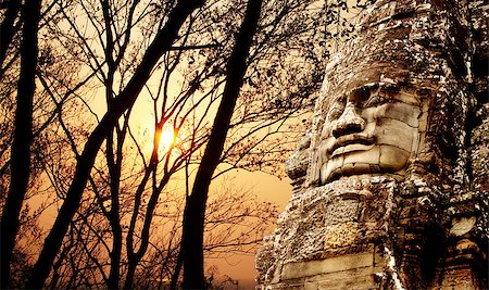 Giant stone face in Prasat Bayon Temple and trees on sunset sky background. Famous landmark Angkor Wat complex, khmer culture, Siem Reap, Cambodia Stock Photo - Budget Royalty-Free & Subscription, Code: 400-08776203