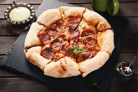 simsearch:400-08960199,k - Hot Homemade Pepperoni Pizza on a rustic wooden table Stock Photo - Budget Royalty-Free & Subscription, Code: 400-08776434