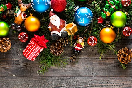 simsearch:400-08113383,k - Merry Christmas Frame with real wood green pine, colorful baubles, gift boxe and other seasonal stuff over an old wooden aged background Stock Photo - Budget Royalty-Free & Subscription, Code: 400-08778349
