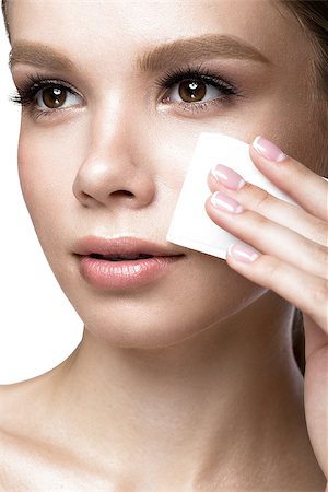 removes eye makeup - Beautiful young girl with wipes for removing makeup and French manicure. Beauty face. Picture taken in the studio on a white background. Stock Photo - Budget Royalty-Free & Subscription, Code: 400-08770982