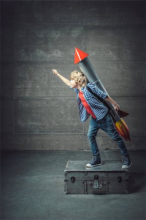 Boy with a rocket in studio Stock Photo - Budget Royalty-Free & Subscription, Code: 400-08771095