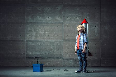 dynamite fuse - Little boy with rocket in studio Photographie de stock - Aubaine LD & Abonnement, Code: 400-08771104