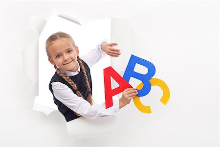 Little girl with alphabet letters and copy space leaning through hole in paper layer Stock Photo - Budget Royalty-Free & Subscription, Code: 400-08771351