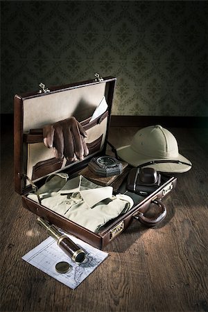 Open leather suitcase with adventurer vintage equipment, including pith hat and brass telescope. Stock Photo - Budget Royalty-Free & Subscription, Code: 400-08771799