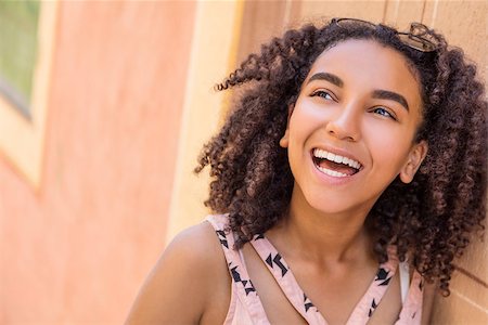 Outdoor portrait of beautiful happy mixed race African American girl teenager female young woman smiling with perfect teeth Stock Photo - Budget Royalty-Free & Subscription, Code: 400-08772219