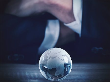 Businessman with world glass sphere with continents on the table Photographie de stock - Aubaine LD & Abonnement, Code: 400-08772370