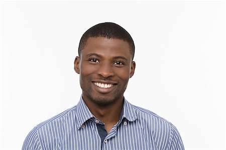 Portrait of happy Afro-American man smiling for camera while posing isolated on white background in studio. Emotions concept. Stock Photo - Budget Royalty-Free & Subscription, Code: 400-08772725