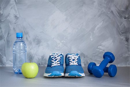 simsearch:400-07754604,k - Sport shoes, dumbbells, apple, bottle of water on gray concrete background. Concept healthy lifestyle, sport and diet. Sport equipment. Stock Photo - Budget Royalty-Free & Subscription, Code: 400-08772914
