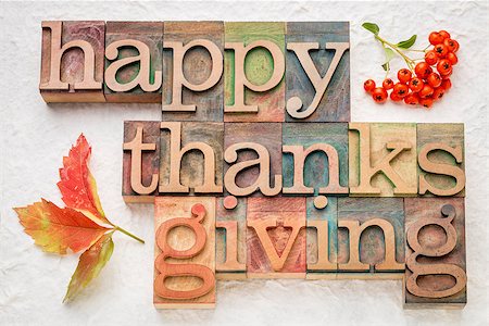 pixelsaway (artist) - Happy Thanksgiving greeting card - word abstract in letterpress wood type with vine leaf and firethorn berries against white lokta paper Foto de stock - Royalty-Free Super Valor e Assinatura, Número: 400-08773309
