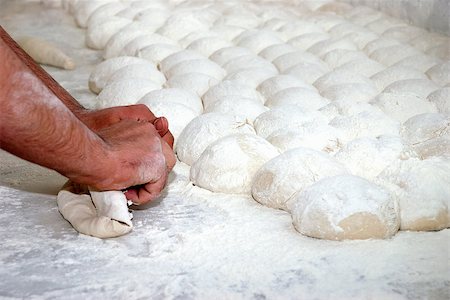 Bread dough being kneaded by baker's hands on flour-covered wooden counter Stock Photo - Budget Royalty-Free & Subscription, Code: 400-08773950