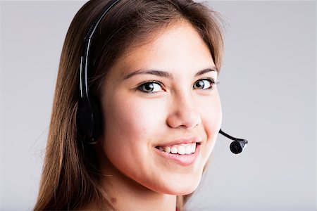 simsearch:400-08831347,k - young woman smiling wearing a headset to answer your customer for service Stock Photo - Budget Royalty-Free & Subscription, Code: 400-08784507