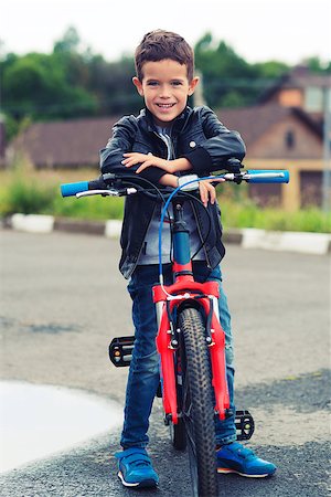 fashion kid with bicycle - Cute boy riding bike in a city Stock Photo - Budget Royalty-Free & Subscription, Code: 400-08784570