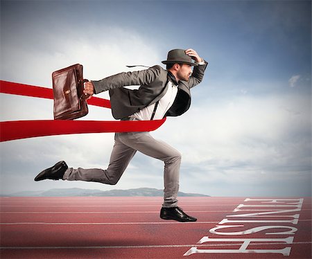 Businessman with bag goes beyond the red ribbon at the arrival of a race Stock Photo - Budget Royalty-Free & Subscription, Code: 400-08784629