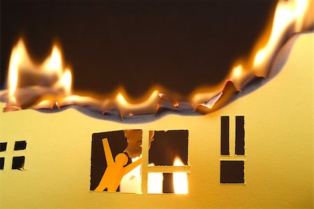 disaster and rescue - Paper man in window of burning house on dark background Foto de stock - Super Valor sin royalties y Suscripción, Código: 400-08785104