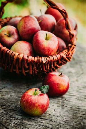 simsearch:825-03626863,k - Fresh harvest of apples. Wooden background with basket full of apples. Nature fruit concept. Stock Photo - Budget Royalty-Free & Subscription, Code: 400-08785551