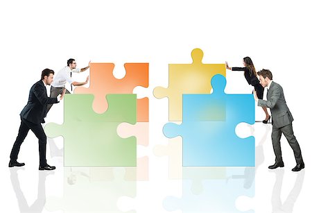 simsearch:400-08668633,k - Concept of teamwork and partnership. Businesspeople pushing pieces of puzzle fit together. Stock Photo - Budget Royalty-Free & Subscription, Code: 400-08786069