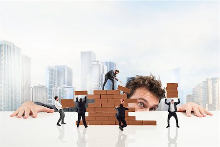 simsearch:400-08668633,k - Businessman watches a teamwork of businesspeople work together by building a brick wall Stock Photo - Budget Royalty-Free & Subscription, Code: 400-08786438