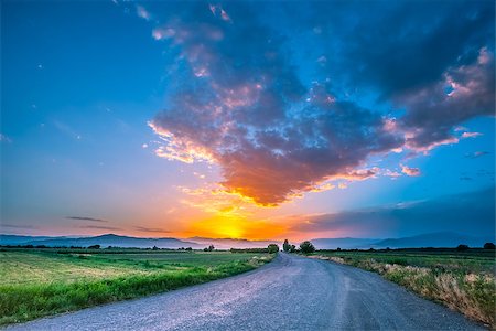 panoramic road drive - magnificent landscape of road on meadow on background of beautiful sunset sky with clouds Stock Photo - Budget Royalty-Free & Subscription, Code: 400-08786788