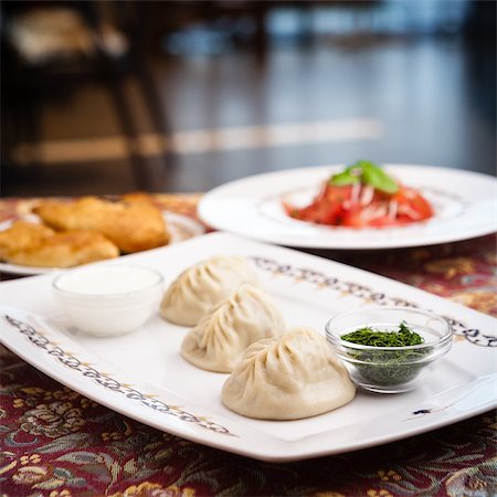 simsearch:400-04822787,k - Manti, samosa and tomato salad served on plates Stock Photo - Budget Royalty-Free & Subscription, Code: 400-08787088