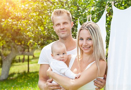 simsearch:400-08787277,k - Happy young family with a cute baby outdoors Stock Photo - Budget Royalty-Free & Subscription, Code: 400-08787278