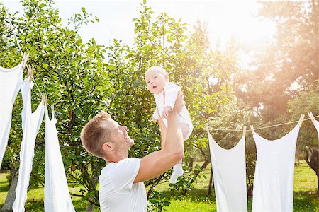 simsearch:400-08787277,k - Happy young father with a cute baby outdoors Stock Photo - Budget Royalty-Free & Subscription, Code: 400-08787281