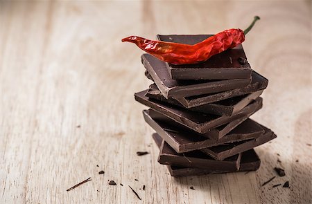 simsearch:400-08789726,k - Red chili peppers on the stack of chocolate bars. Photographie de stock - Aubaine LD & Abonnement, Code: 400-08788051