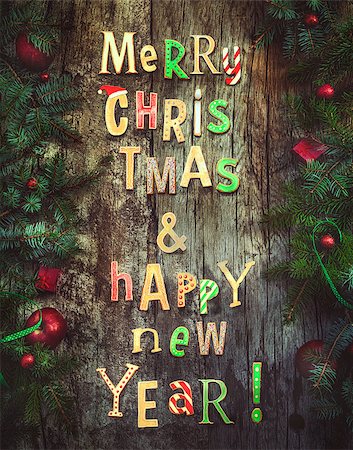 simsearch:400-07614271,k - Christmas greeting card. Xmas wreath card with with gingerbread letters on wooden background. Christmas ornaments on wood with candy and ribbons. Foto de stock - Royalty-Free Super Valor e Assinatura, Número: 400-08788319