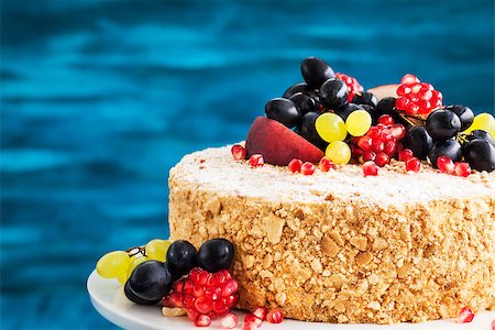 Delicious homemade honey cake decorated with fresh fruits and berries Photographie de stock - Aubaine LD & Abonnement, Code: 400-08788725