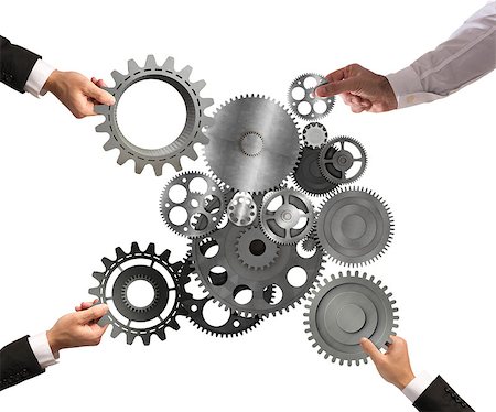 Teamwork of businesspeople work together and combine pieces of gears to a mechanical system Stock Photo - Budget Royalty-Free & Subscription, Code: 400-08788827