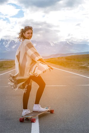 Young cute girl rides skateboard on road, outdoor Stock Photo - Budget Royalty-Free & Subscription, Code: 400-08789138