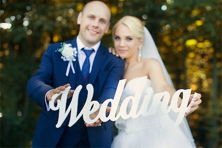 Newlyweds are holding the letters on a walk in the summer park Stock Photo - Budget Royalty-Free & Subscription, Code: 400-08789577