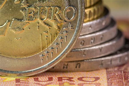 Euro money: Macro view of euro coin and bill with the word Euro focused. Suitable for financial, monetary, euro or European Union concepts and ideas Stock Photo - Budget Royalty-Free & Subscription, Code: 400-08789651