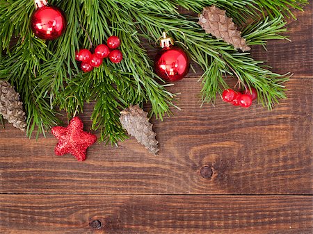 fascinadora (artist) - Christmas fir tree with decoration on dark wooden board background. Border art design with Christmas tree, cones and red baubles. Xmas and new year concept. Top view or flat lay with copy space Stock Photo - Budget Royalty-Free & Subscription, Code: 400-08794260