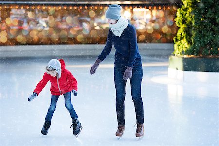 family of two enjoying ice skating at winter at outdoor skating rink at snowy weather, winter and family concept Photographie de stock - Aubaine LD & Abonnement, Code: 400-08794465