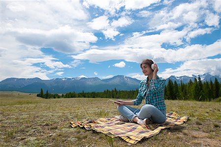 rammellzee (artist) - Woman in headphones listening music in a field and at the mountain Stock Photo - Budget Royalty-Free & Subscription, Code: 400-08794477