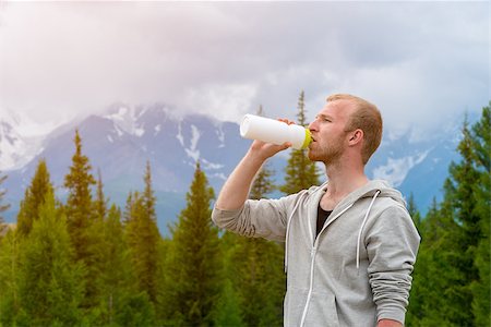 rammellzee (artist) - Men runner drinking water outdoors. Mountains background. Altay. Russia Stock Photo - Budget Royalty-Free & Subscription, Code: 400-08794472