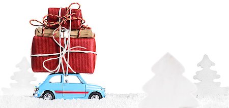 Blue retro toy car delivering Christmas or New Year gifts, isolated on white Stock Photo - Budget Royalty-Free & Subscription, Code: 400-08795072