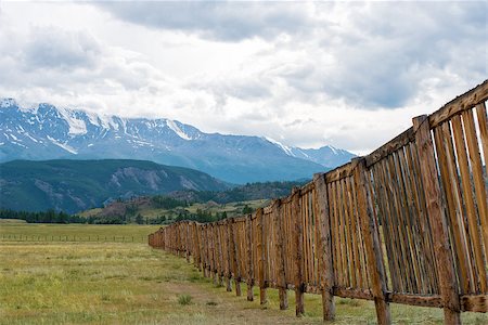 rammellzee (artist) - Long wooden fence in a field. In the distance the mountains Stock Photo - Budget Royalty-Free & Subscription, Code: 400-08795356