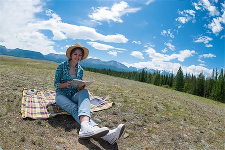 rammellzee (artist) - Young woman reading book and sitting in a field. Mountains background Stock Photo - Budget Royalty-Free & Subscription, Code: 400-08795434