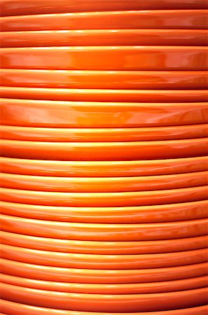 Stack of ceramic orange plates close-up Stockbilder - Microstock & Abonnement, Bildnummer: 400-08795682