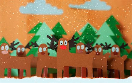 sharpner (artist) - Team Reindeer Santa Claus standing in snowy forest. In front of red nosed Rudolph. The whole picture is cutting out from colored paper Stockbilder - Microstock & Abonnement, Bildnummer: 400-08795866