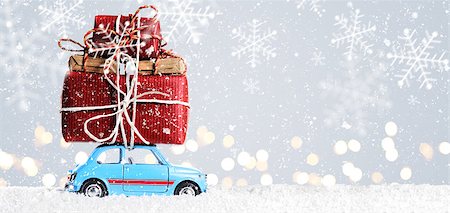 Blue retro toy car delivering Christmas or New Year gifts on festive gray background Stock Photo - Budget Royalty-Free & Subscription, Code: 400-08795882