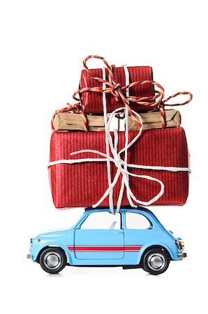 Blue retro toy car delivering Christmas or New Year gifts, isolated on white Stock Photo - Budget Royalty-Free & Subscription, Code: 400-08795897