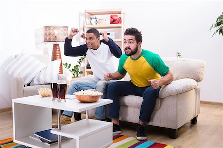 shouting television - Image of friends men watching football game, screaming and shouting, drinking alcohol drinks and eating pop corn at home. Stock Photo - Budget Royalty-Free & Subscription, Code: 400-08796110