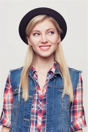 skinny teen girl - Closeup fashion studio portrait of hipster young smiling woman in black hat and denim vest over light grey background Stock Photo - Budget Royalty-Free & Subscription, Code: 400-08796532