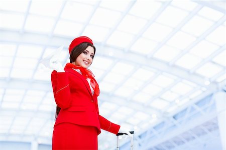 simsearch:400-04429524,k - Young stewardess with a plane at airport Stock Photo - Budget Royalty-Free & Subscription, Code: 400-08790164